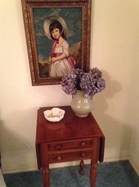 Needlepoint art of a young girl; small side table