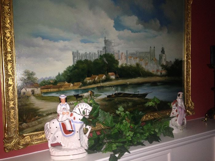 Framed art of a European castle;  eye-catching male and female figurines