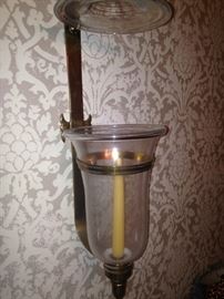 One of two brass sconces