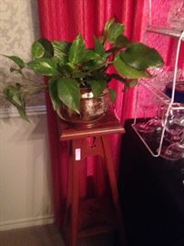 One of two plant stands and brass planter with ivy