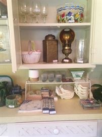 Variety of napkins, candles, glassware, and brass