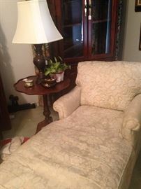 Upholstered chaise lounge; antique pie crust side table