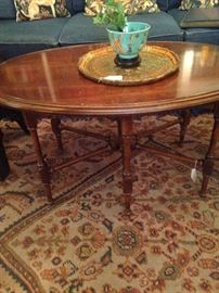 Oval coffee table with cross bar support