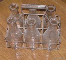 Old Milk Bottles in Metal Crate