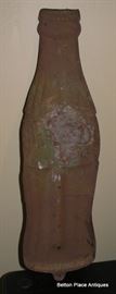 Old rusty Coca Cola metal sign, around bottle size