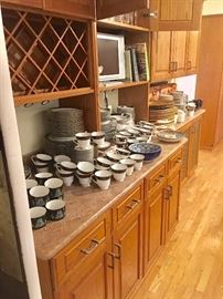 The kitchen is filled with multiple sets of china, crystal (including Riedel), glass, porcelain, pottery, and more