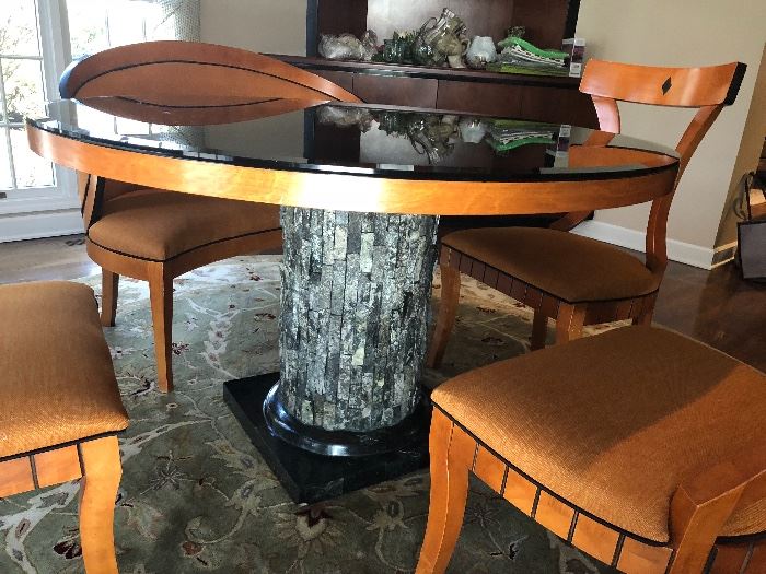 Custom table with a "tree bark" base.  Beveled black glass top is removable.  3 side chairs, cushioned, and a curved bench