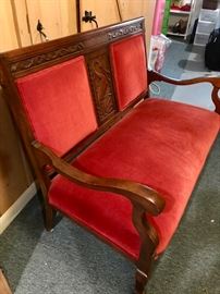 Antique Victorian wood and velvet loveseat. Reupholstered. Good condition. Beautiful wood in very fine condition. Red cotton velvet. Length 46", height 35"