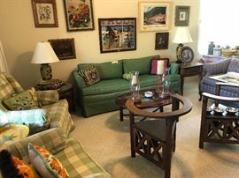 Living rood is full of art, chairs, sofa and decorations.