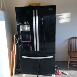 Side by side refridge, has freezer at bottom. 