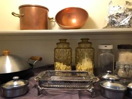 Large selection of kitchen items, copper pots, glass jars, bakeware.
