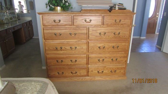 11 drawer tall chest of oak wood