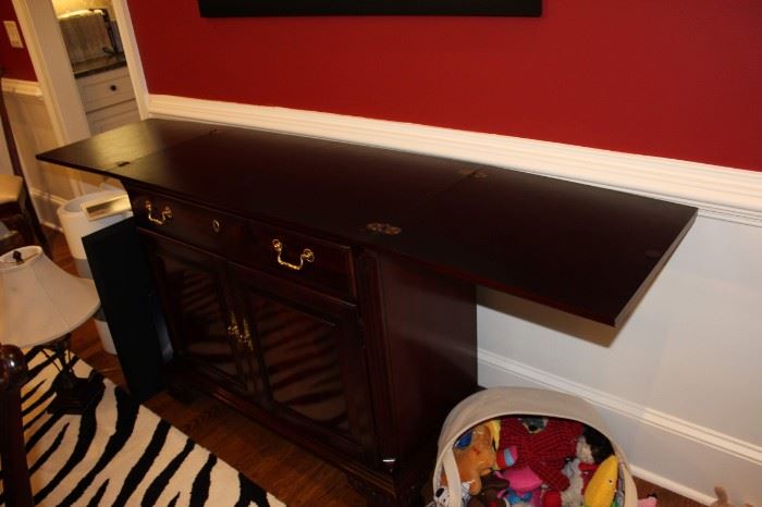 Leaves fold into center of mahogany buffet