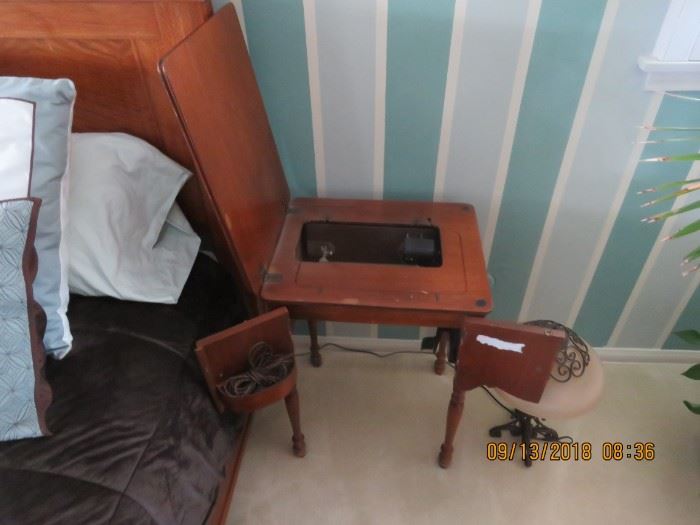 Small cabinet with a Singer sewing machine.