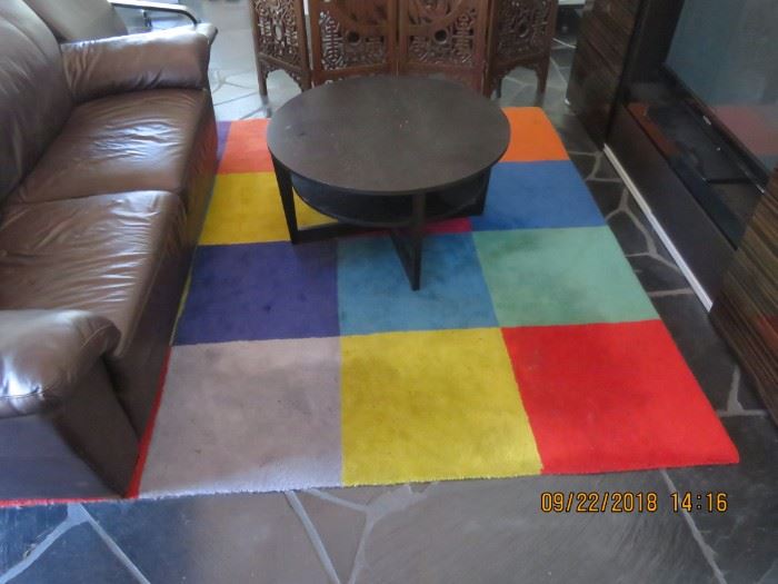 Colorful rug and small round table.