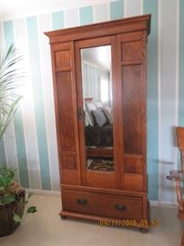 Medium size oak armoire with beveled glass.