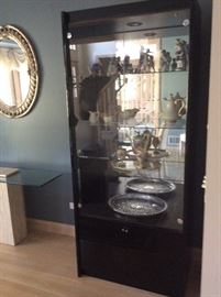 Two black  and glass cabinets.