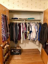 Closet full of men's clothes.