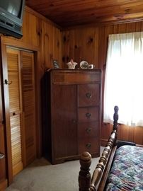 Armoire for bedroom 1. Has hanging bar in left compartment. 