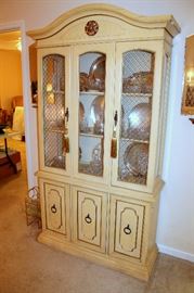 Small china cabinet full of crystal and silverplate