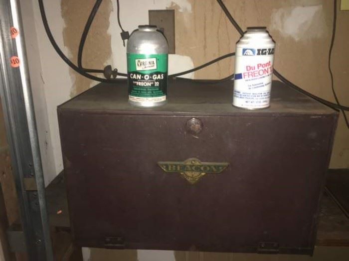 Two old cans of Freon, located on the smalls table in the family room by the cashier
