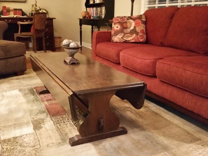 Dark stained pine drop leaf coffee table. 