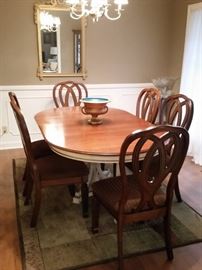 Six new padded chairs complimenting a mid-century dining table with 2 leaves. White base.  ( The original chairs that are white with gold trim and blue padded seats are also for sale. A few need to be reupholstered.  They would make great accent chairs throughout the home.) 