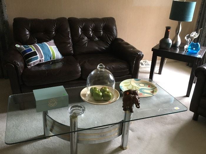 Leather loveseat and chrome and glass coffee table