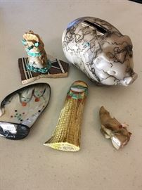 An assortment of fetishes and horsehair pottery piggybank