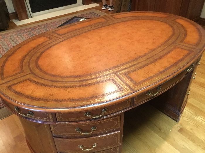 Maitland & Smith rare leather wrapped partners desk. Oval shaped 70” L x 45” W x 30”H