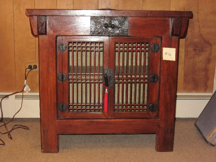 Antique Korean Storage chest. Wood with iron fittings. Front panel replaced about 20 years ago with open-faced doors. Top has two pieces, front piece is removable. Inside is lined with paper covered with calligraphy. 