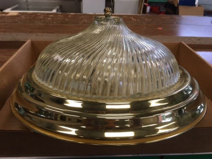 One light fixture with a gold metal color 13" base, 6" high and a swirl pattern cone shaped glass globe.
