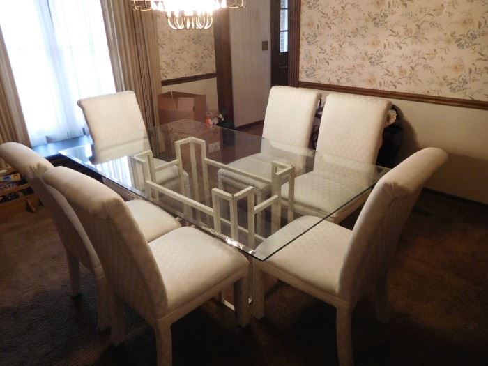glass  top dining  room  table  and  white  chairs