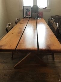 A cross-legged plank table made personally by the home owner and architect, Elmer Stuck.