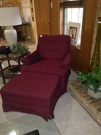 One of two matching burgundy club chairs; one ottoman