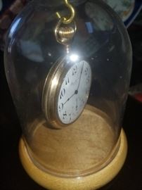 Gold pocket watch in display case
