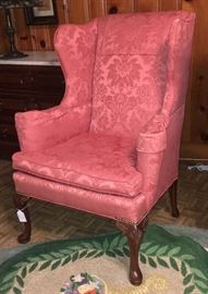 Wing back chair in rose colored damask print