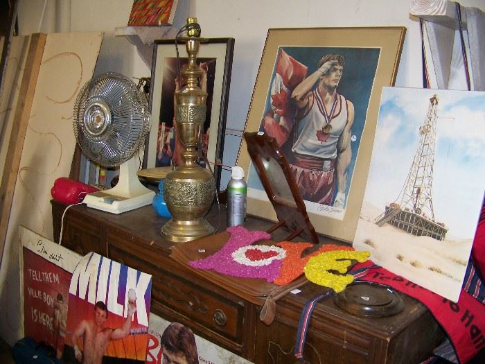 Small buffet, posters and lamp.