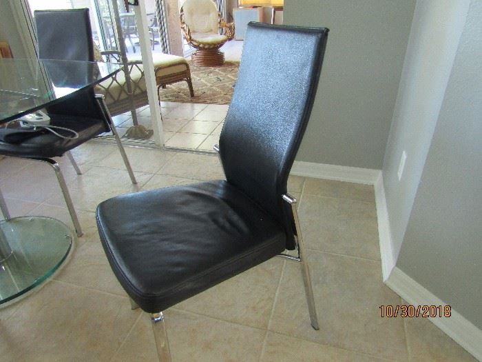 4 ALL LEATHER BLACK AND CHROME CONTEMPORARY DINING CHAIRS WITH FALL BACK FOR CONVENIENCE..SCAN DESIGN