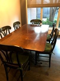 Custom solid maple table with rod iron base. Includes six chairs with rush seat and cushion. Cost $300