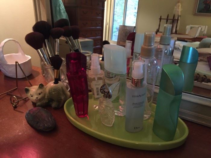 Perfume bottles and makeup brushes.
