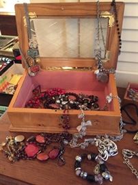 Assorted costume jewelry and jewelry boxes.