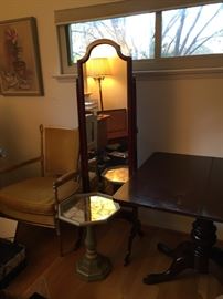 Small tables, armchairs and standing mirror.