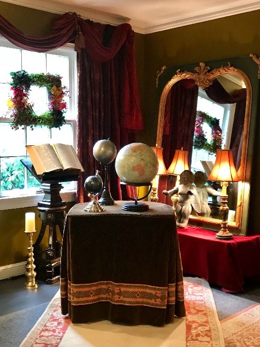 A corner of the LR 
Velvet tablecloth with a collection on globes an antique  podium with Victorian plaster mirror with gilded trim and a bronze putti