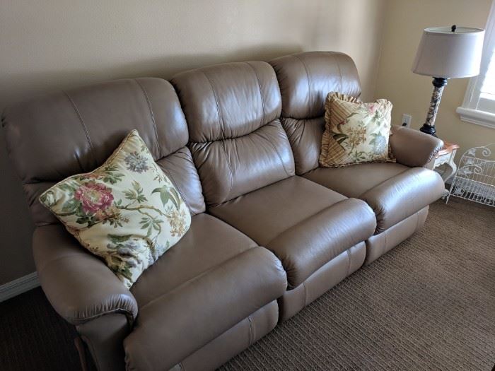 Tan leather sofa with recliners on both ends. Sofa is in like-new condition
