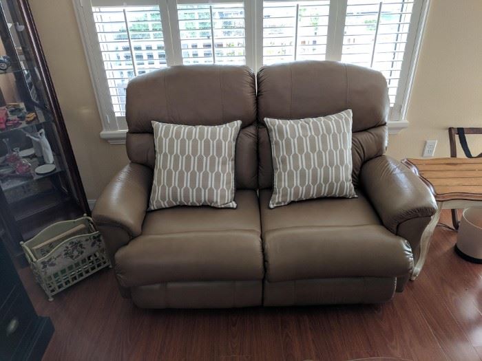Matching leather loveseat is also in like-new condition and has dual recliners