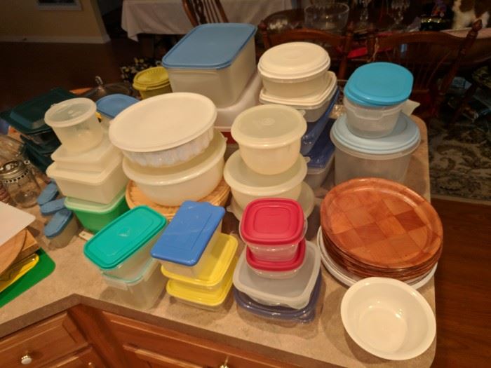 Plastic containers of various sizes including many Tupperware pieces