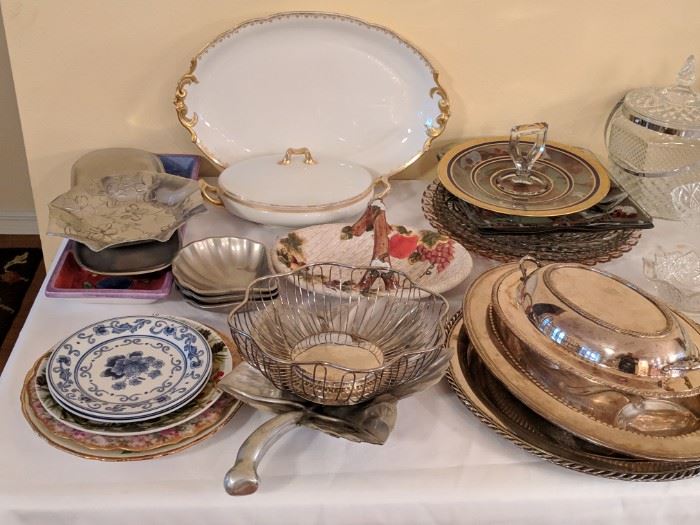 Numerous serving platters and dishes in addition to several antique pieces