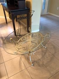 Glass top coffee table with wrought iron base