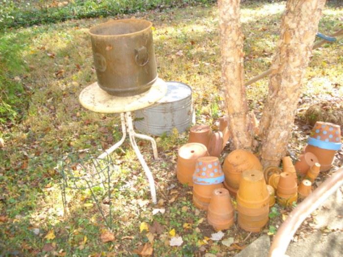 Iron table, clay pots, containers 